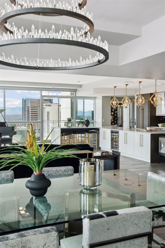 dining area with beverage cooler and a city view