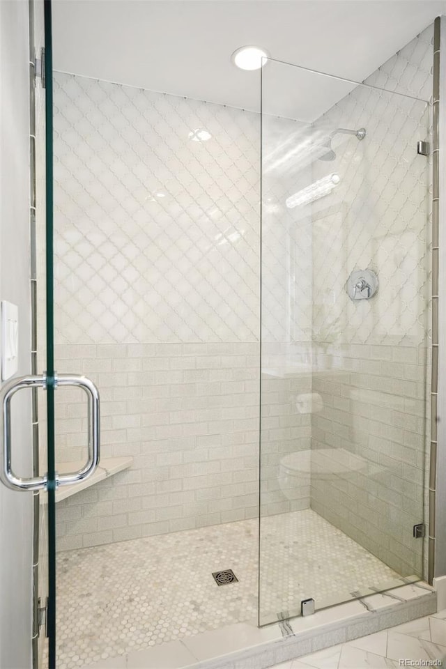 full bath with a tile shower