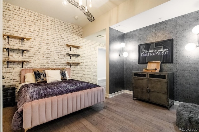 bedroom featuring wood finished floors and baseboards