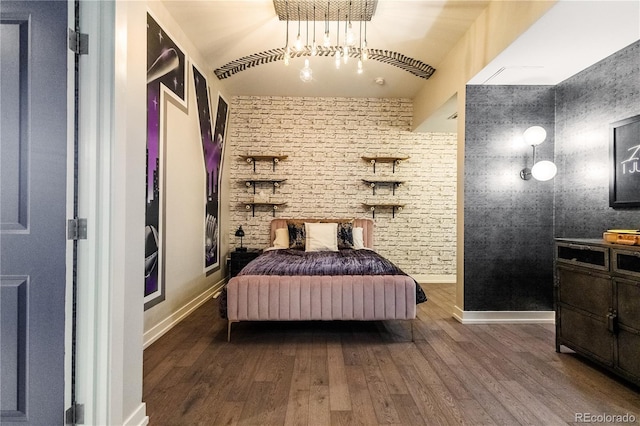 bedroom with dark wood finished floors and baseboards