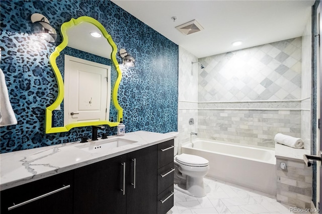 bathroom with visible vents, toilet, tub / shower combination, vanity, and wallpapered walls