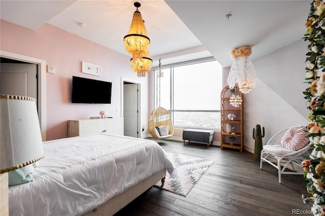 bedroom featuring dark wood-type flooring, a notable chandelier, and baseboards