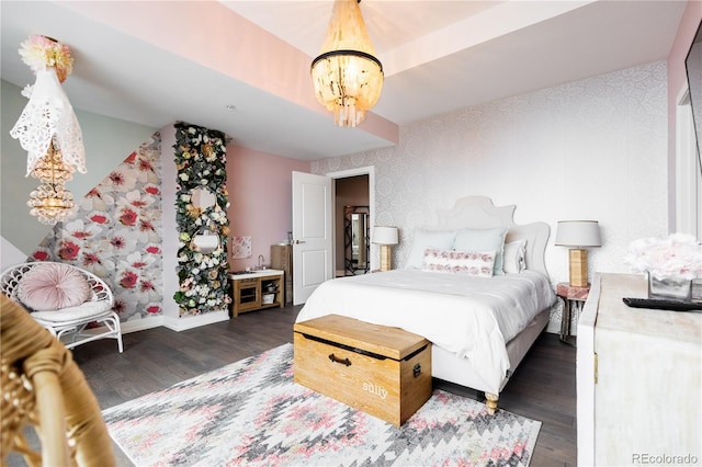 bedroom featuring a chandelier, dark wood finished floors, and baseboards