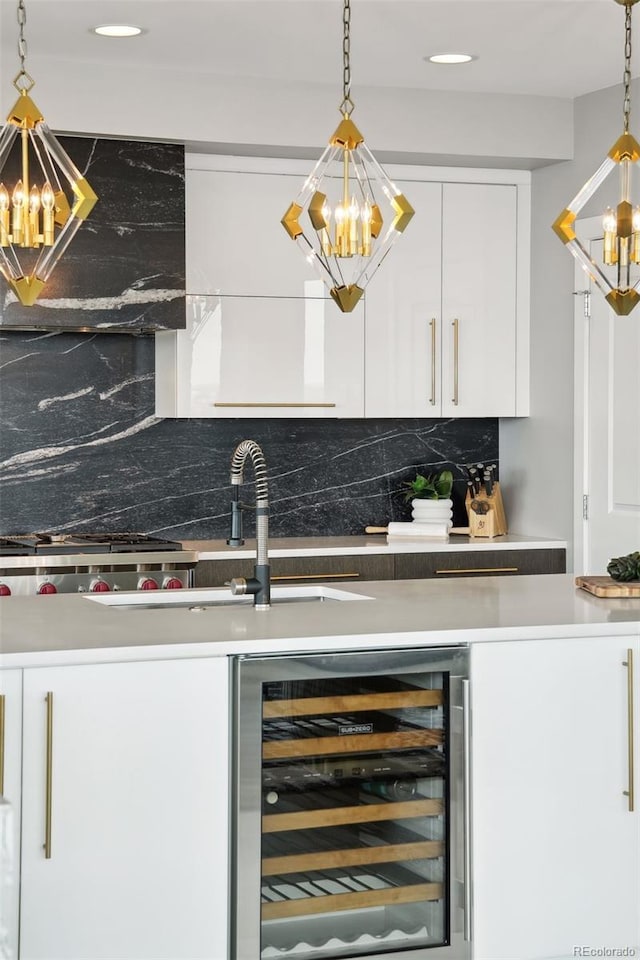 bar with hanging light fixtures, beverage cooler, backsplash, and a notable chandelier