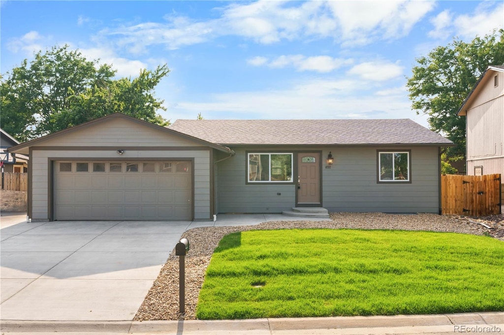 ranch-style house with a garage and a front yard