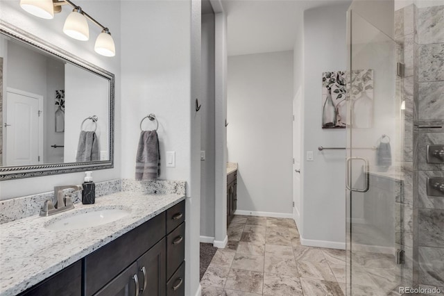 bathroom with walk in shower and vanity