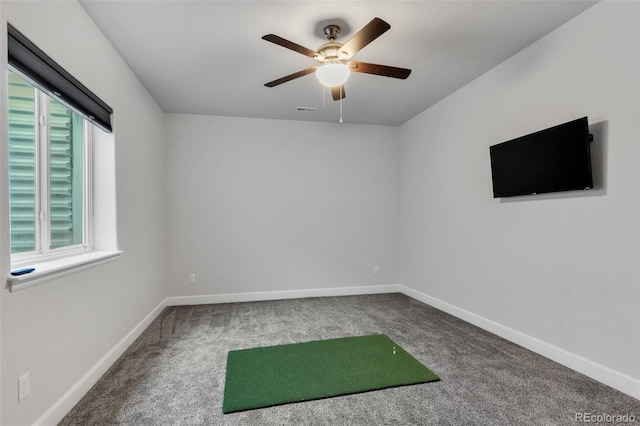 carpeted spare room featuring ceiling fan