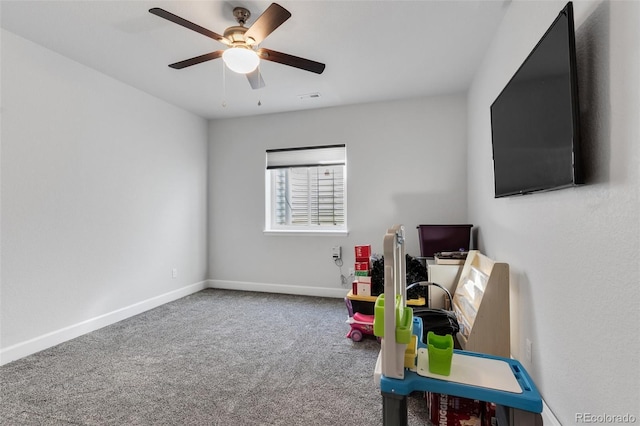 rec room with ceiling fan and carpet