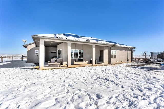 snow covered property with a trampoline