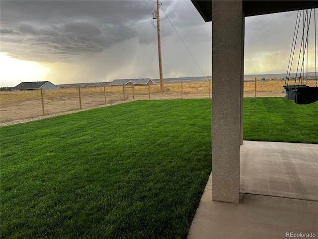 yard at dusk with a patio area