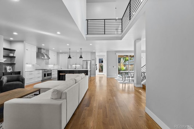 living room with sink and light hardwood / wood-style flooring