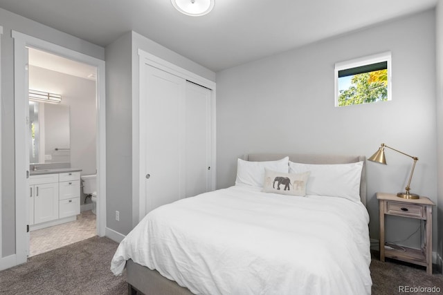 carpeted bedroom featuring ensuite bath, a closet, and sink