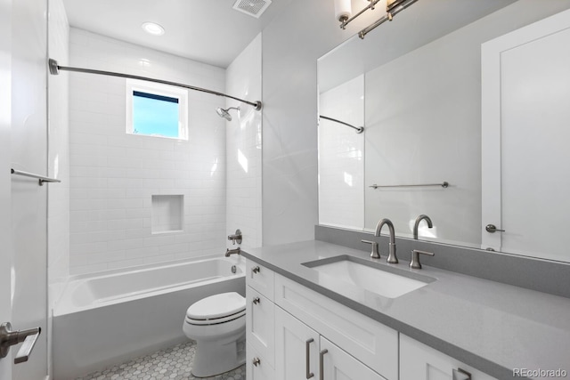 full bathroom with tile patterned flooring, vanity, toilet, and tiled shower / bath