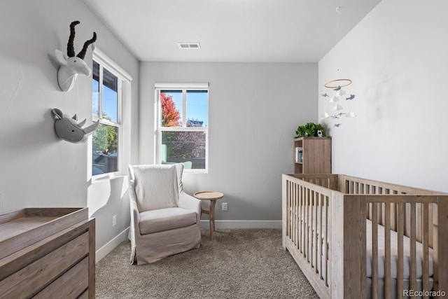 bedroom with carpet flooring and a crib