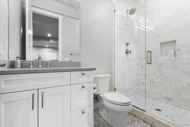 bathroom featuring toilet, vanity, and walk in shower