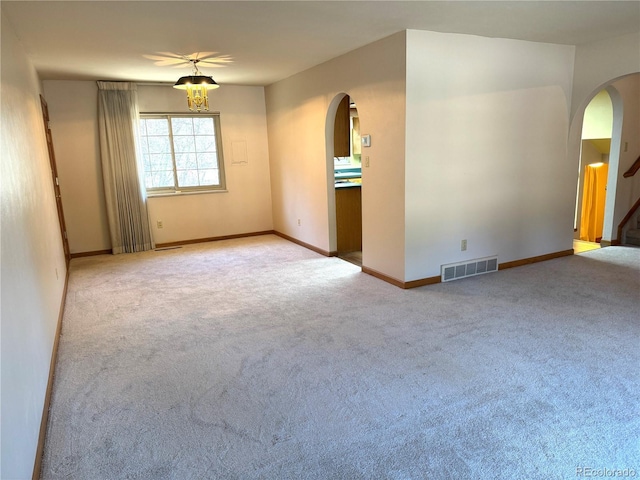 280 Raven Hills Rd, Colorado Springs, CO 80919 - empty room with carpet floors, arched walkways, baseboards, and visible vents