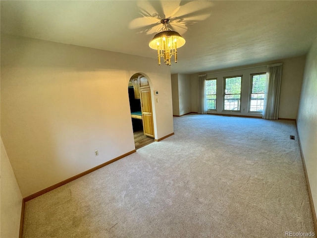 280 Raven Hills Rd, Colorado Springs, CO 80919 - carpeted empty room featuring baseboards, arched walkways, and a ceiling fan