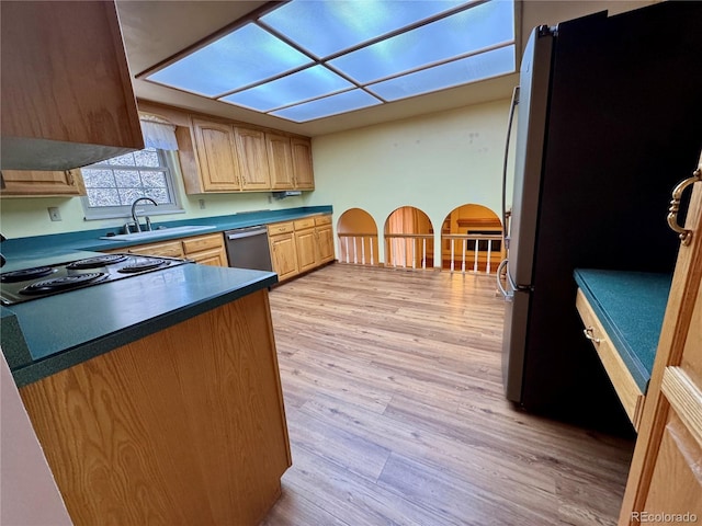 280 Raven Hills Rd, Colorado Springs, CO 80919 - kitchen with light brown cabinetry, dark countertops, a sink, stainless steel appliances, and light wood-type flooring