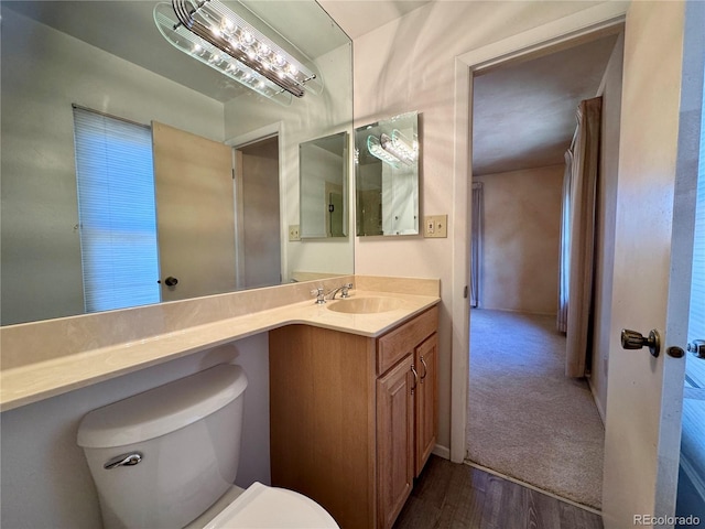 280 Raven Hills Rd, Colorado Springs, CO 80919 - bathroom featuring vanity, wood finished floors, and toilet