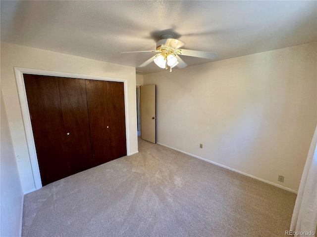 280 Raven Hills Rd, Colorado Springs, CO 80919 - unfurnished bedroom with a ceiling fan, baseboards, light carpet, and a closet