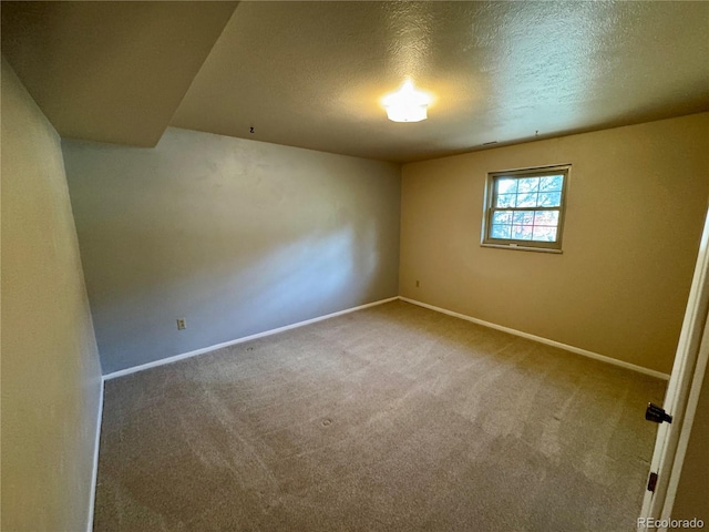 280 Raven Hills Rd, Colorado Springs, CO 80919 - carpeted empty room with baseboards and a textured ceiling