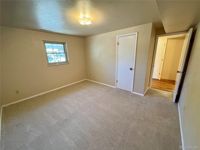 280 Raven Hills Rd, Colorado Springs, CO 80919 - unfurnished bedroom with carpet flooring, a textured ceiling, baseboards, and visible vents