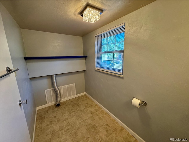 280 Raven Hills Rd, Colorado Springs, CO 80919 - laundry area featuring visible vents, a textured ceiling, baseboards, and tile patterned floors