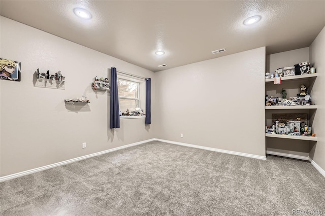 unfurnished room with baseboards, carpet, recessed lighting, and visible vents