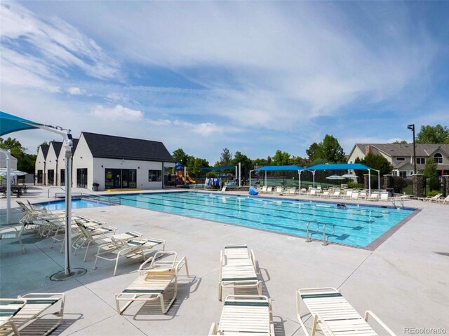 pool featuring fence and a patio area