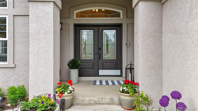 9468 E Aspen Hill Ln, Lone Tree, CO 80124 - view of exterior entry with french doors and stucco siding