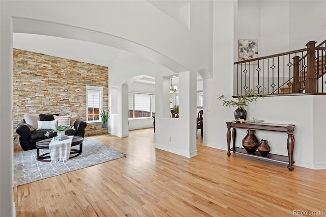 9468 E Aspen Hill Ln, Lone Tree, CO 80124 - entrance foyer featuring wood finished floors, high vaulted ceiling, and arched walkways