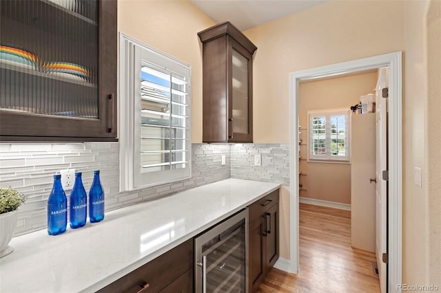 9468 E Aspen Hill Ln, Lone Tree, CO 80124 - bar with wine cooler, backsplash, and light wood-type flooring
