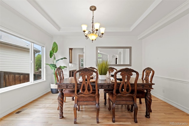 9468 E Aspen Hill Ln, Lone Tree, CO 80124 - dining room featuring a tray ceiling, a chandelier, light wood finished floors, and ornamental molding