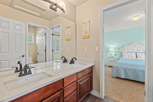 9468 E Aspen Hill Ln, Lone Tree, CO 80124 - bathroom with double vanity, connected bathroom, and wood finished floors