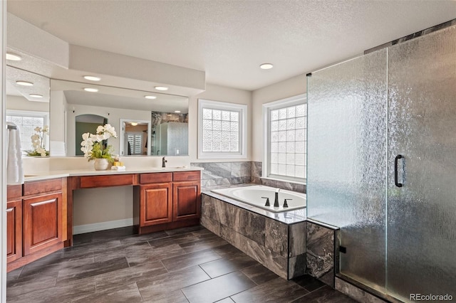 9468 E Aspen Hill Ln, Lone Tree, CO 80124 - bathroom featuring vanity, a garden tub, a shower stall, and recessed lighting