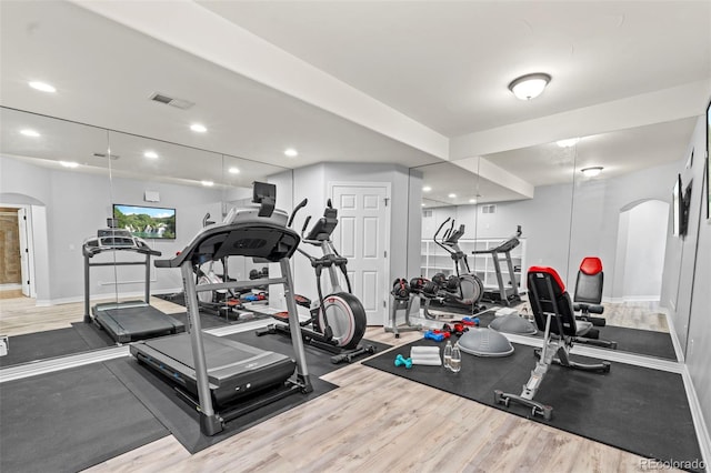 9468 E Aspen Hill Ln, Lone Tree, CO 80124 - exercise area with arched walkways, wood finished floors, and recessed lighting