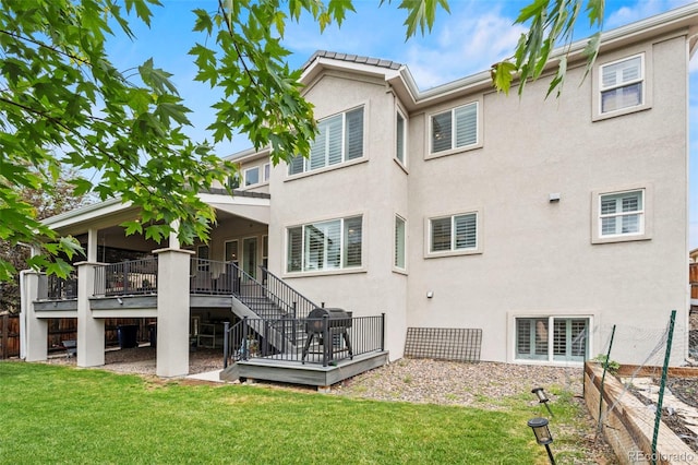 9468 E Aspen Hill Ln, Lone Tree, CO 80124 - back of property with stairway, stucco siding, and a wooden deck