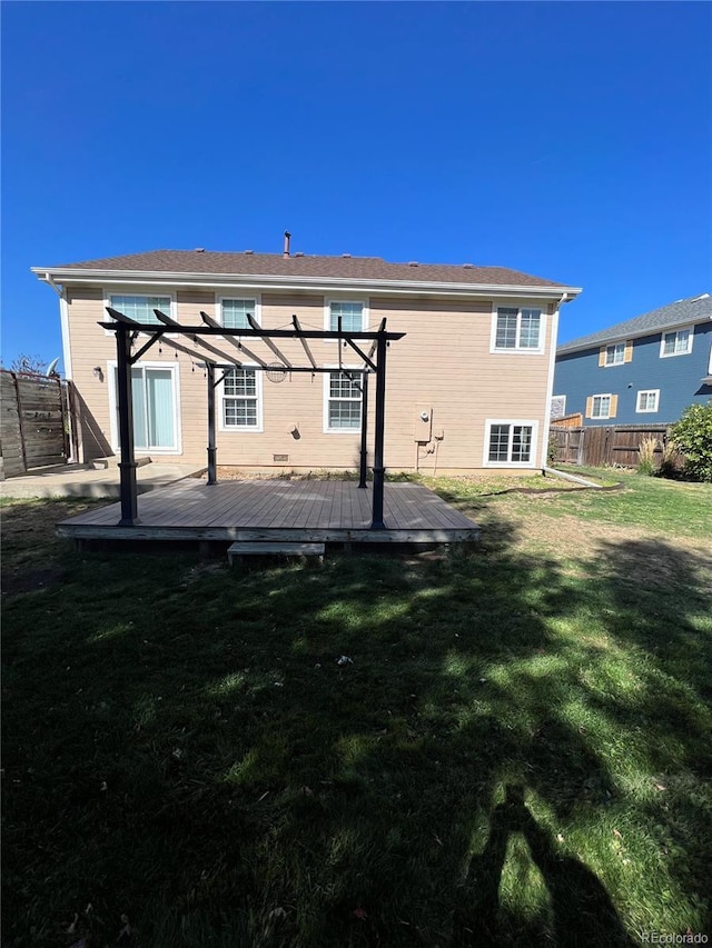 2604 S Dunkirk Ct, Aurora, CO 80013 - back of property featuring fence, a wooden deck, a lawn, and a pergola