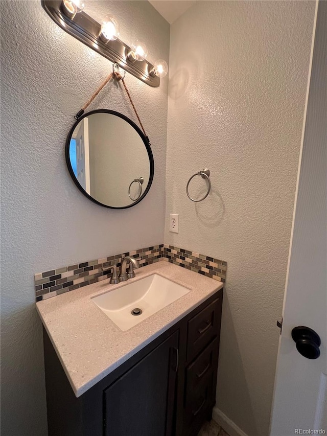 bathroom with vanity and decorative backsplash