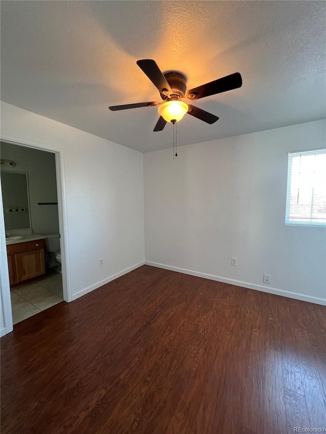 unfurnished room with a textured ceiling, hardwood / wood-style floors, and ceiling fan