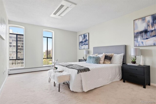 3131 E Alameda Ave Unit 803, Denver, CO 80209 - carpeted bedroom with a baseboard radiator and a textured ceiling