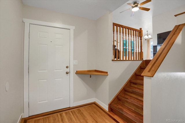 1010 Vondelpark Dr, Colorado Springs, CO 80907 - foyer with wood finished floors, a ceiling fan, and stairs