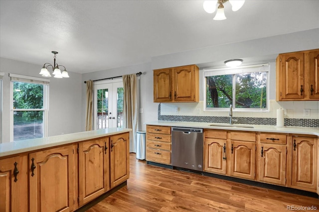 1010 Vondelpark Dr, Colorado Springs, CO 80907 - kitchen featuring dishwasher, decorative backsplash, light countertops, french doors, and brown cabinets