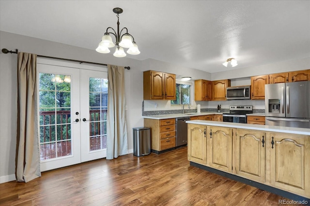1010 Vondelpark Dr, Colorado Springs, CO 80907 - kitchen featuring stainless steel appliances, french doors, light countertops, a chandelier, and wood finished floors