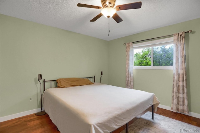1010 Vondelpark Dr, Colorado Springs, CO 80907 - bedroom featuring wood finished floors, a ceiling fan, and a textured ceiling