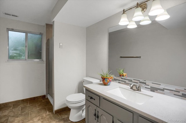 1010 Vondelpark Dr, Colorado Springs, CO 80907 - full bath with vanity, tasteful backsplash, a shower, and stone finish flooring