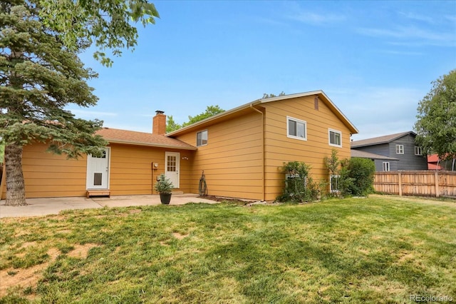 1010 Vondelpark Dr, Colorado Springs, CO 80907 - back of house with a chimney and a patio