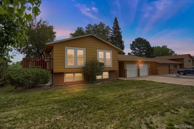 1010 Vondelpark Dr, Colorado Springs, CO 80907 - split level home with a garage, brick siding, driveway, and a lawn