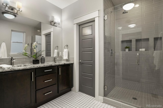 bathroom featuring vanity, tile patterned flooring, and a shower with door