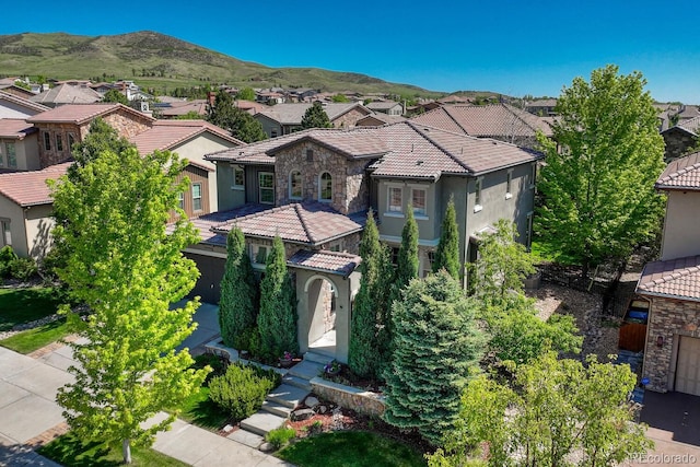 15235 W Iliff Ave, Lakewood, CO 80228 - mediterranean / spanish home with a residential view, stucco siding, a tiled roof, and a mountain view